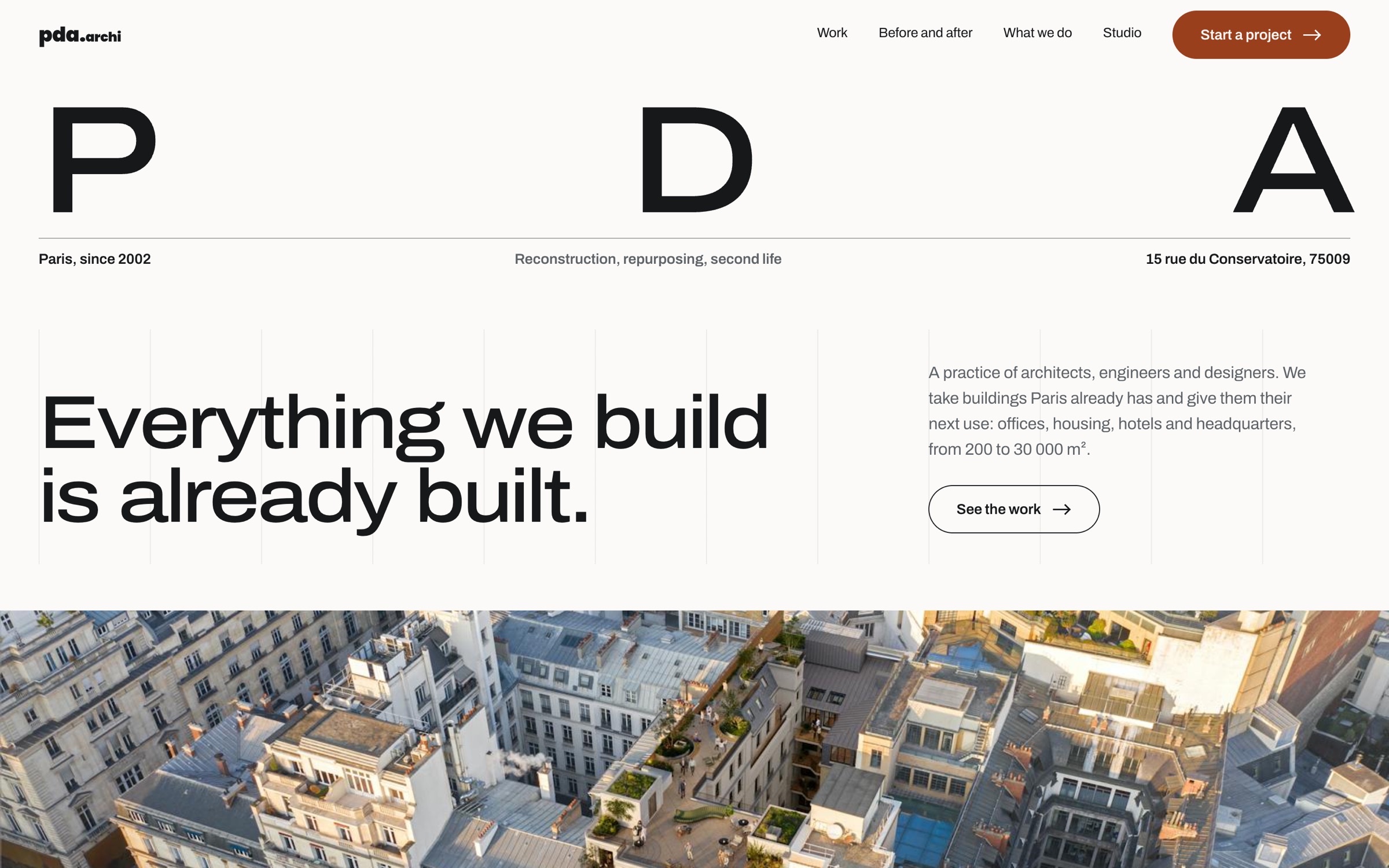 The redesigned PDA Architecture home page: the PDA wordmark across the full width, the claim 'Everything we build is already built', and an aerial photograph of a Paris block.